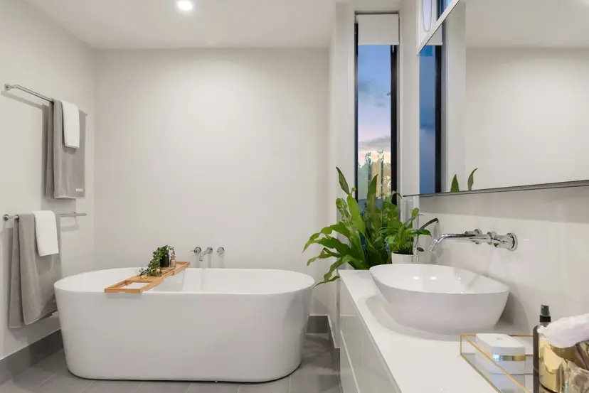 Remodeled bathroom featuring a frameless glass walk-in shower and floating double vanity